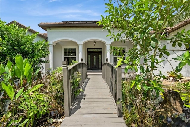 850 25th St SW, Naples, FL 34117 - view of exterior entry featuring covered porch and stucco siding