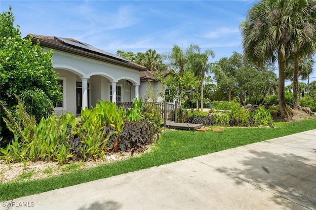 850 25th St SW, Naples, FL 34117 - view of home's exterior with stucco siding and solar panels
