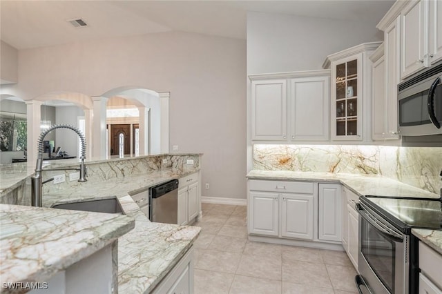 850 25th St SW, Naples, FL 34117 - kitchen with appliances with stainless steel finishes, a sink, tasteful backsplash, light stone countertops, and vaulted ceiling