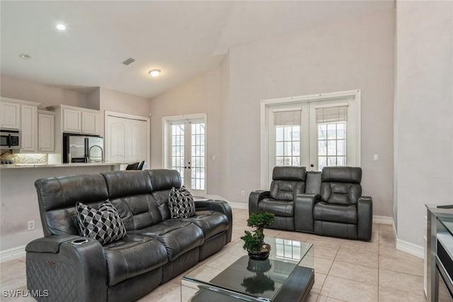 850 25th St SW, Naples, FL 34117 - living area featuring french doors, baseboards, high vaulted ceiling, and light tile patterned floors