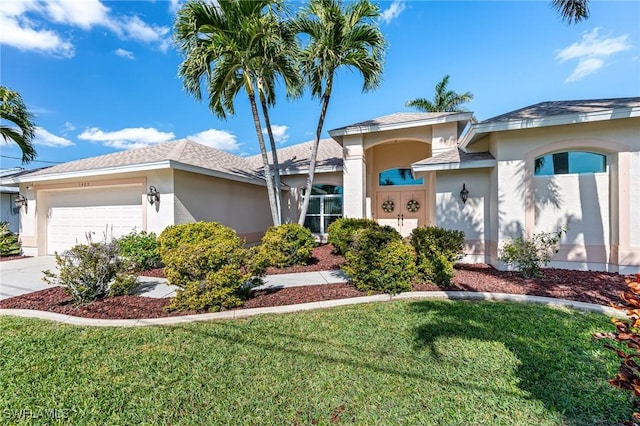 view of front of home with a garage and a front yard