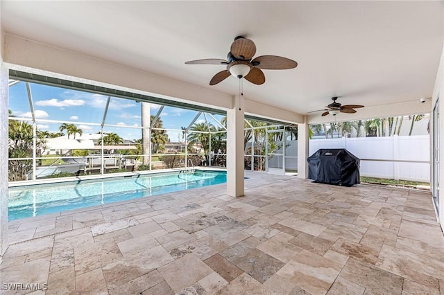 view of pool featuring ceiling fan, grilling area, a patio area, and glass enclosure