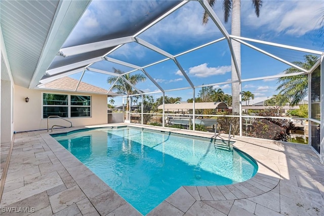 view of pool featuring a patio area and glass enclosure