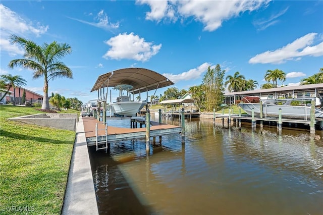 view of dock with a yard and a water view