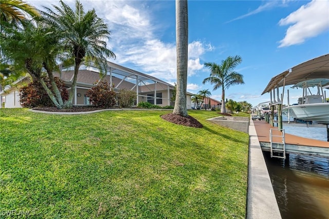 view of yard featuring a water view, glass enclosure, and a boat dock