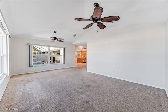 unfurnished living room with lofted ceiling, light carpet, and ceiling fan