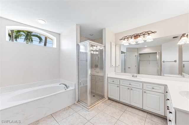 bathroom with tile patterned flooring, vanity, and separate shower and tub