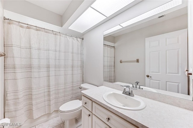 bathroom featuring vanity, tile patterned floors, and toilet