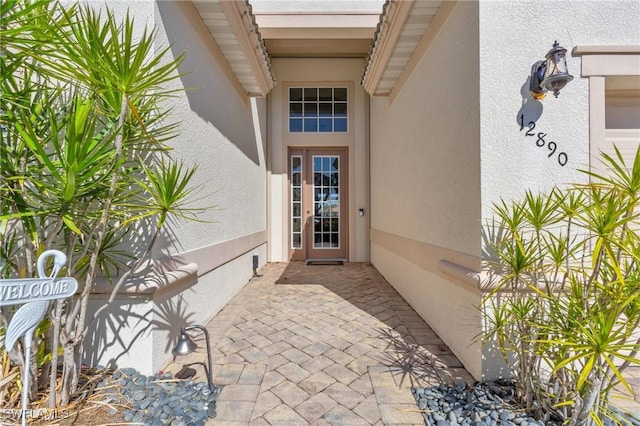12890 Kentfield Ln, Fort Myers, FL 33913 - view of exterior entry featuring stucco siding