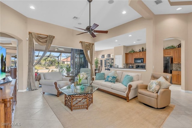 12890 Kentfield Ln, Fort Myers, FL 33913 - living area featuring a ceiling fan, light tile patterned flooring, arched walkways, visible vents, and recessed lighting