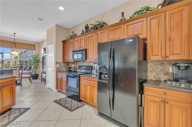 kitchen featuring pendant lighting, decorative backsplash, black appliances, and light tile patterned flooring