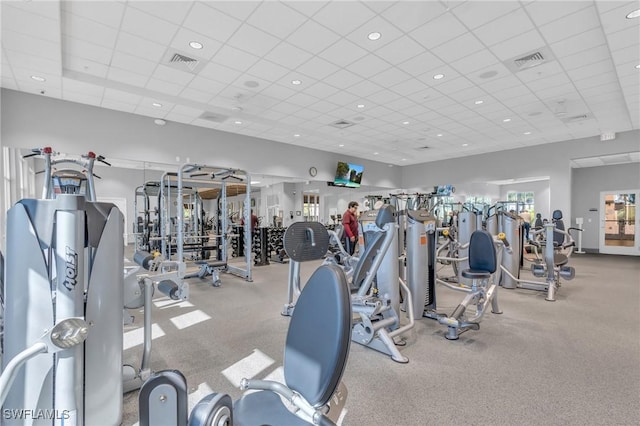 exercise room with a paneled ceiling