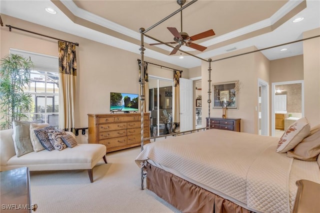 bedroom with ensuite bathroom, crown molding, ceiling fan, and a tray ceiling