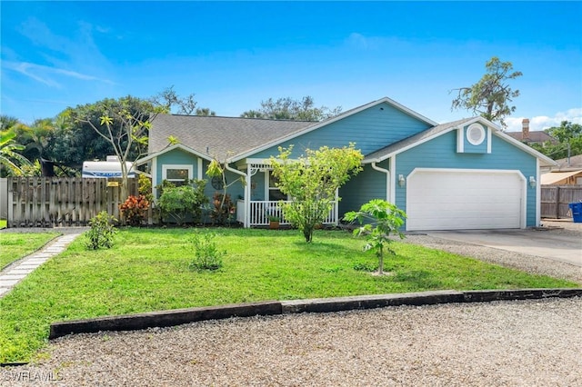 view of front of house with a garage, a front yard, and a porch