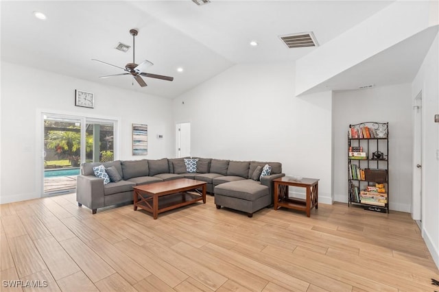 living room featuring ceiling fan, high vaulted ceiling, and light hardwood / wood-style floors