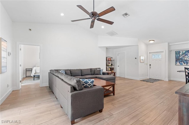 living room featuring ceiling fan, lofted ceiling, and light wood-type flooring