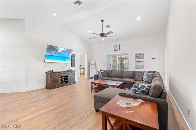 living room with ceiling fan, high vaulted ceiling, and light wood-type flooring