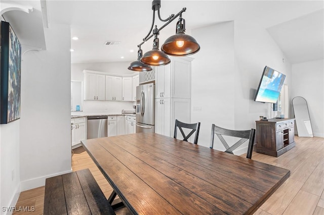 dining area with lofted ceiling