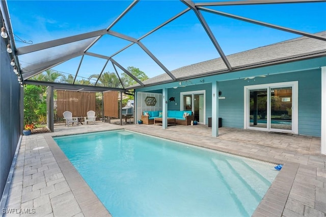 view of pool featuring ceiling fan, outdoor lounge area, a patio area, and a lanai