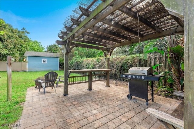 view of patio / terrace with area for grilling, a shed, and a pergola