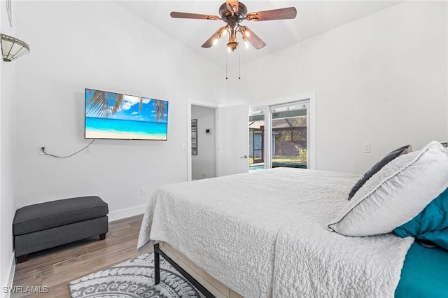 bedroom featuring access to exterior, ceiling fan, and light hardwood / wood-style floors