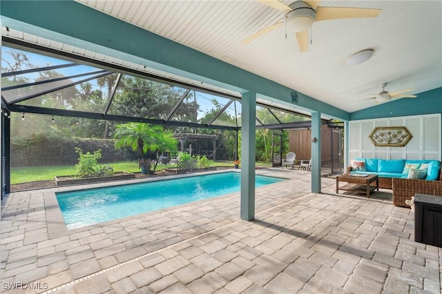 view of pool with an outdoor living space, a lanai, a patio, and ceiling fan