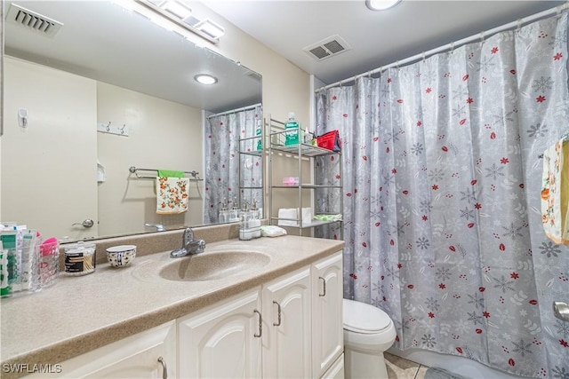 bathroom with vanity, tile patterned floors, and toilet