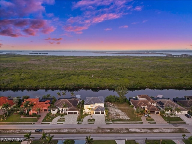 aerial view at dusk with a water view