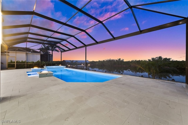 pool at dusk with an in ground hot tub, a water view, a patio, and glass enclosure