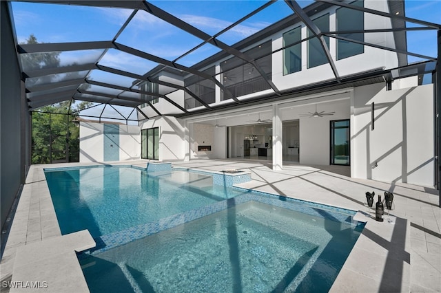 view of swimming pool featuring ceiling fan, a patio area, and glass enclosure