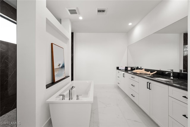 bathroom with vanity and a bath