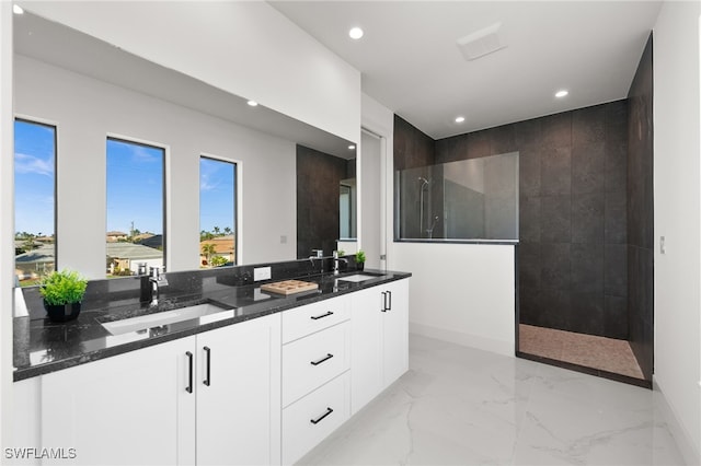 bathroom featuring vanity and a tile shower