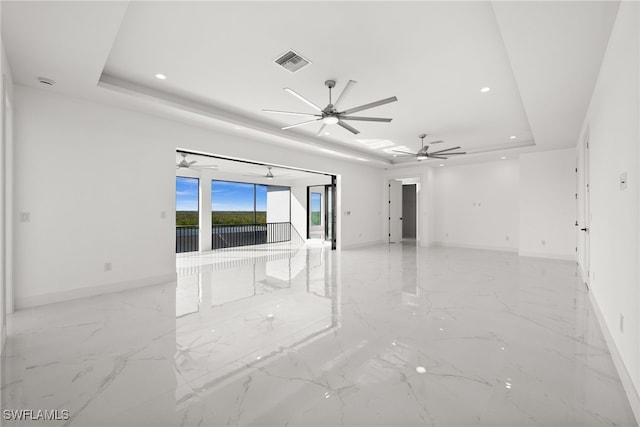 empty room featuring a tray ceiling