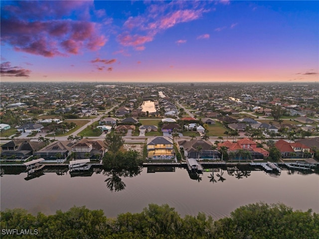 aerial view at dusk with a water view