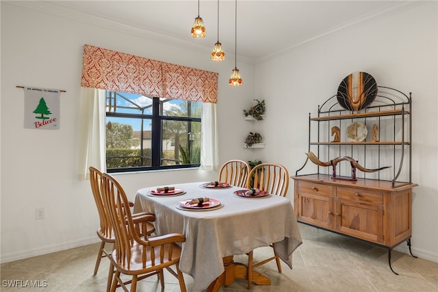 dining room featuring crown molding and light tile patterned floors