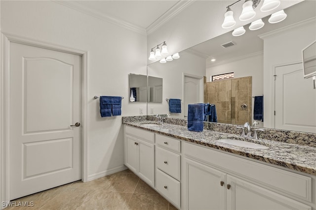 bathroom featuring vanity, tile patterned flooring, ornamental molding, and tiled shower