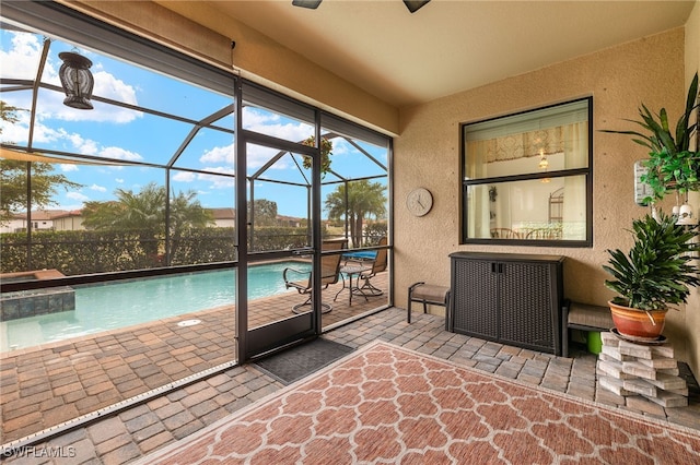 view of swimming pool featuring glass enclosure and a patio