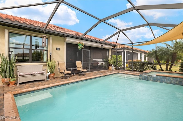 view of swimming pool with an in ground hot tub, a sunroom, a lanai, and a patio