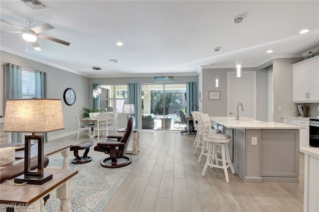 living room featuring plenty of natural light and ornamental molding