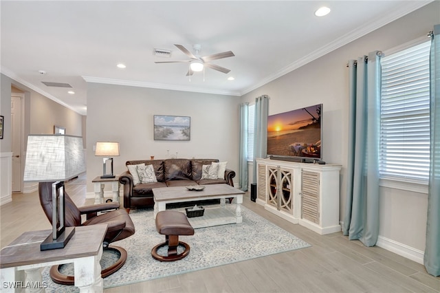 living room with crown molding, ceiling fan, and light hardwood / wood-style floors