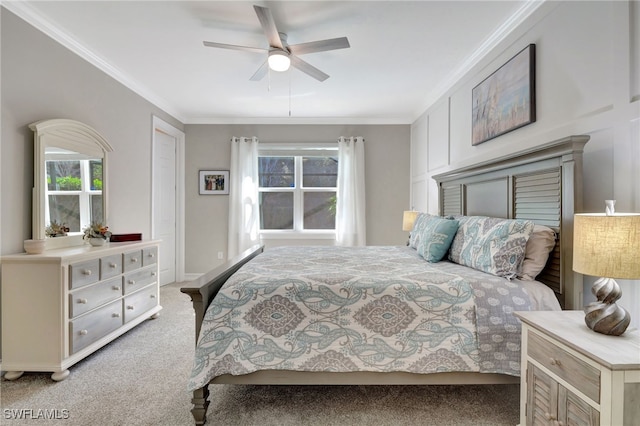 carpeted bedroom featuring crown molding and ceiling fan