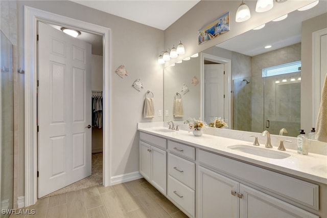 bathroom featuring vanity and a shower with door