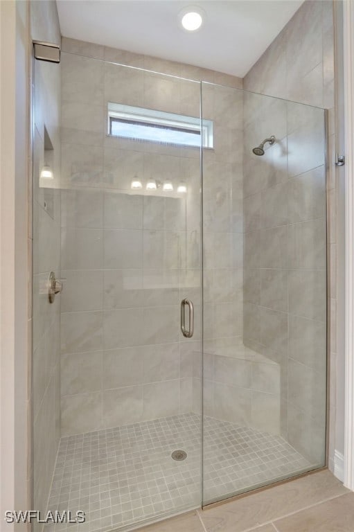 bathroom with a shower with door