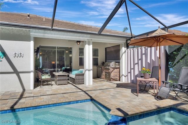 view of swimming pool with area for grilling, a patio, ceiling fan, and an outdoor kitchen