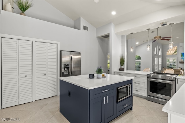 kitchen with white cabinetry, light tile patterned floors, high vaulted ceiling, and appliances with stainless steel finishes