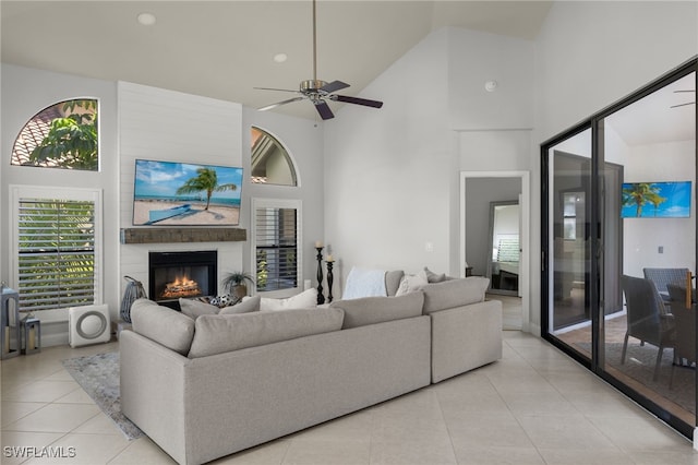 tiled living room featuring high vaulted ceiling and ceiling fan