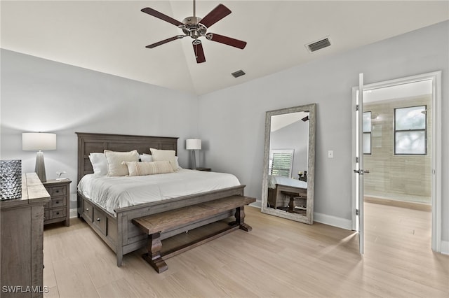 bedroom featuring ceiling fan, vaulted ceiling, multiple windows, and light wood-type flooring