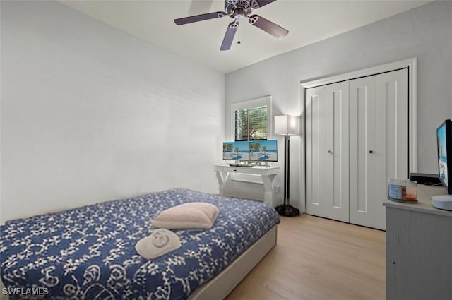 bedroom with ceiling fan, a closet, and light wood-type flooring