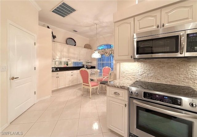 kitchen with appliances with stainless steel finishes, pendant lighting, backsplash, ornamental molding, and light tile patterned floors