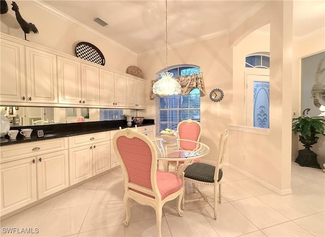 dining area with ornamental molding and light tile patterned floors